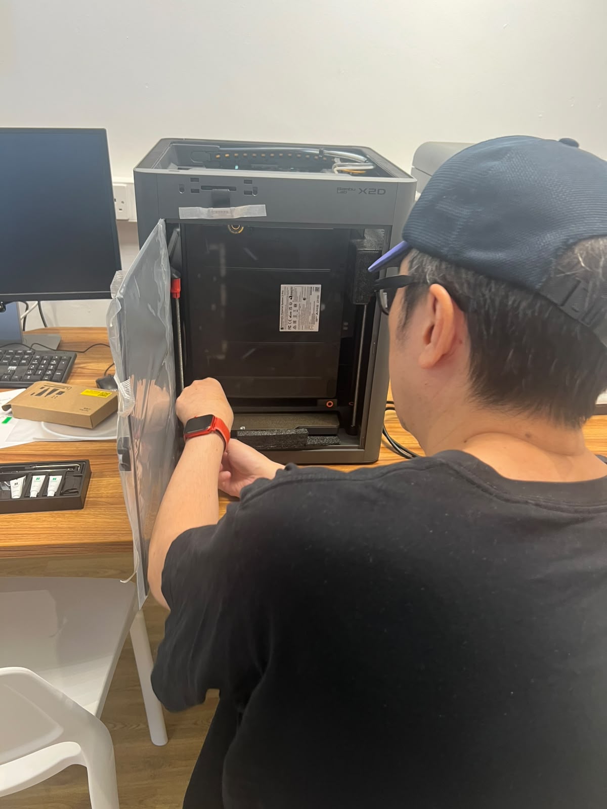 Unpacking and setting up a Bambu Lab X2D printer at a community centre